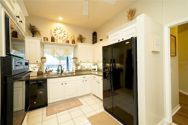 8760 Plantation Ridge Blvd, Lakeland, FL 33809 - kitchen with black appliances, a sink, dark countertops, decorative backsplash, and white cabinetry