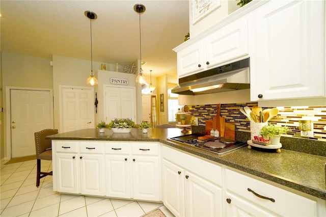 8760 Plantation Ridge Blvd, Lakeland, FL 33809 - kitchen featuring under cabinet range hood, stovetop, a peninsula, backsplash, and light tile patterned floors