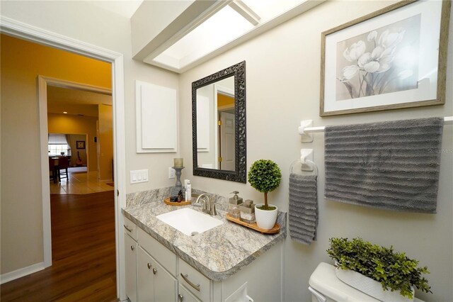 8760 Plantation Ridge Blvd, Lakeland, FL 33809 - half bathroom featuring vanity, wood finished floors, and toilet