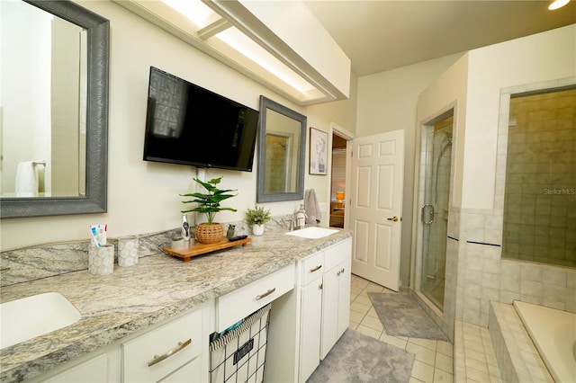 8760 Plantation Ridge Blvd, Lakeland, FL 33809 - full bathroom with double vanity, a stall shower, tile patterned floors, and a bath