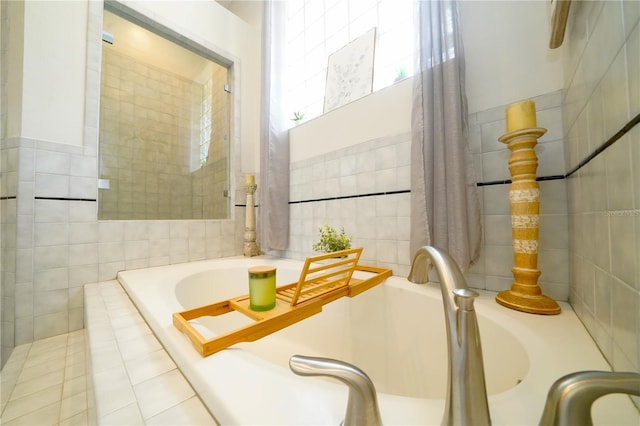 8760 Plantation Ridge Blvd, Lakeland, FL 33809 - bathroom featuring tile walls and a garden tub