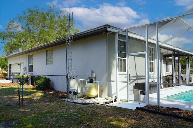 8760 Plantation Ridge Blvd, Lakeland, FL 33809 - view of home's exterior featuring a garage, an outdoor pool, a lanai, stucco siding, and a gate