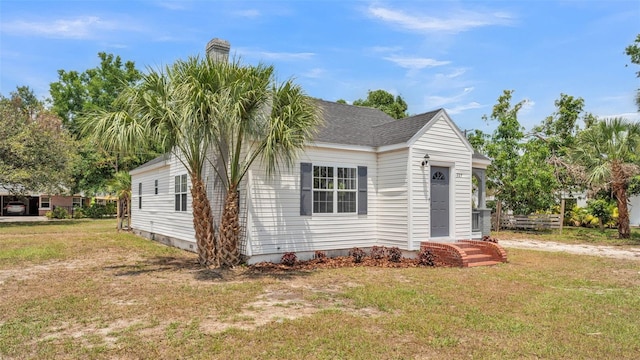 725 Ave B SW, Winter Haven, FL 33880 - view of home's exterior with a lawn and a chimney