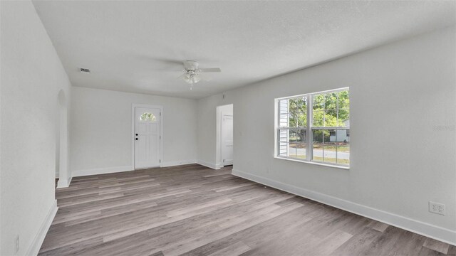 725 Ave B SW, Winter Haven, FL 33880 - spare room featuring plenty of natural light, a ceiling fan, and wood finished floors