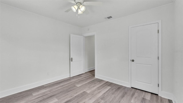 725 Ave B SW, Winter Haven, FL 33880 - unfurnished bedroom with light wood finished floors, baseboards, and ceiling fan