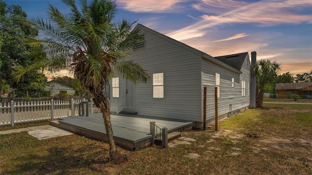 725 Ave B SW, Winter Haven, FL 33880 - property exterior at dusk featuring fence and a deck