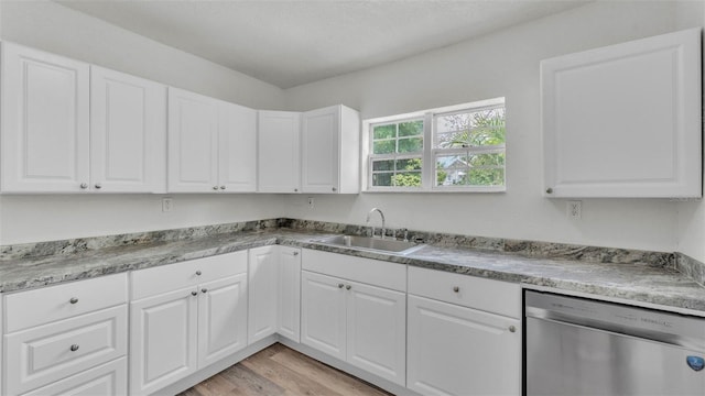 725 Ave B SW, Winter Haven, FL 33880 - kitchen featuring stainless steel dishwasher, light wood-style flooring, a sink, and white cabinets