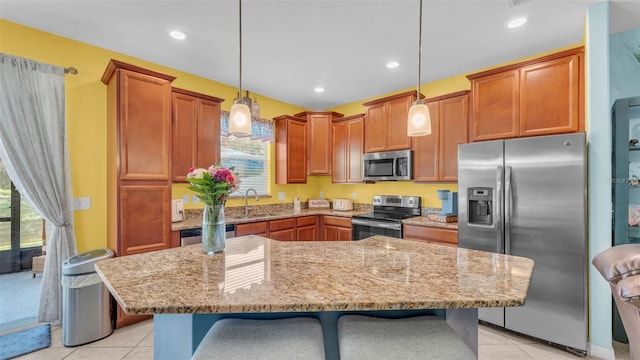 6435 Sedgeford Dr, Lakeland, FL 33811 - kitchen featuring stainless steel appliances, a sink, a kitchen bar, light stone counters, and recessed lighting