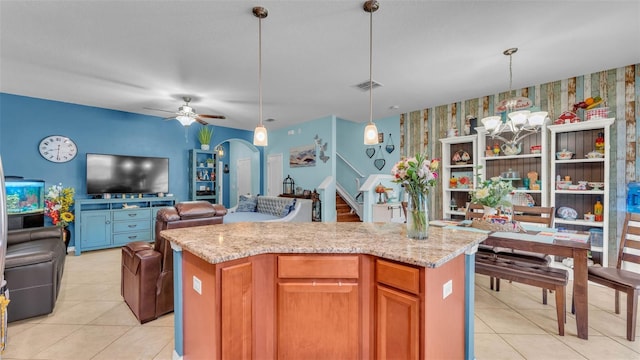 6435 Sedgeford Dr, Lakeland, FL 33811 - kitchen with open floor plan, light tile patterned flooring, wallpapered walls, ceiling fan, and a kitchen island