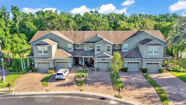 6435 Sedgeford Dr, Lakeland, FL 33811 - view of front of house with driveway, a garage, and stucco siding