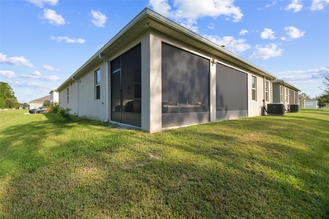 15354 Sweet Springs Bnd, Odessa, FL 33556 - view of side of home featuring a sunroom, cooling unit, a yard, and stucco siding