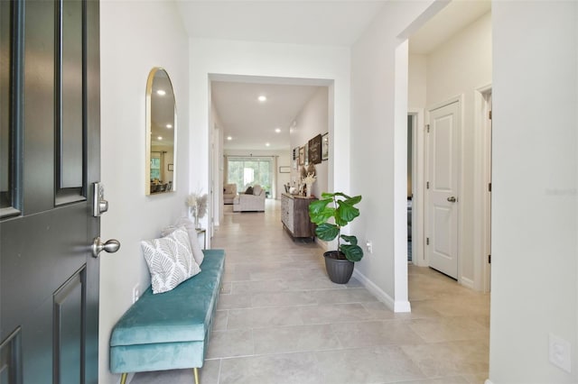 15354 Sweet Springs Bnd, Odessa, FL 33556 - foyer entrance with light tile patterned floors, recessed lighting, arched walkways, and baseboards