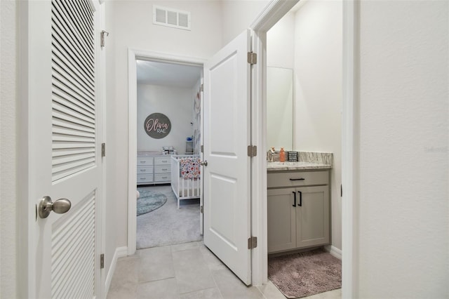 15354 Sweet Springs Bnd, Odessa, FL 33556 - hallway featuring light tile patterned flooring, light colored carpet, and baseboards