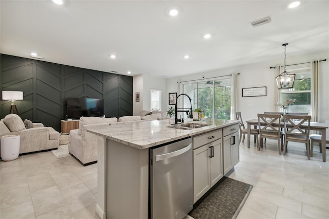 15354 Sweet Springs Bnd, Odessa, FL 33556 - kitchen featuring dishwasher, a sink, open floor plan, light stone countertops, and a center island with sink
