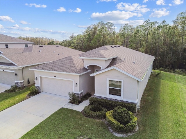 15354 Sweet Springs Bnd, Odessa, FL 33556 - view of front of home featuring an attached garage, stucco siding, a front lawn, and driveway