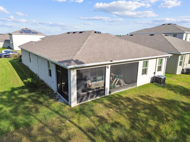 15354 Sweet Springs Bnd, Odessa, FL 33556 - back of property featuring a shingled roof, a sunroom, central AC unit, and a lawn