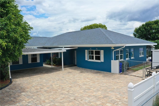 1328 Edgewater Beach Dr, Lakeland, FL 33805 - back of house with fence, a shingled roof, and a gate