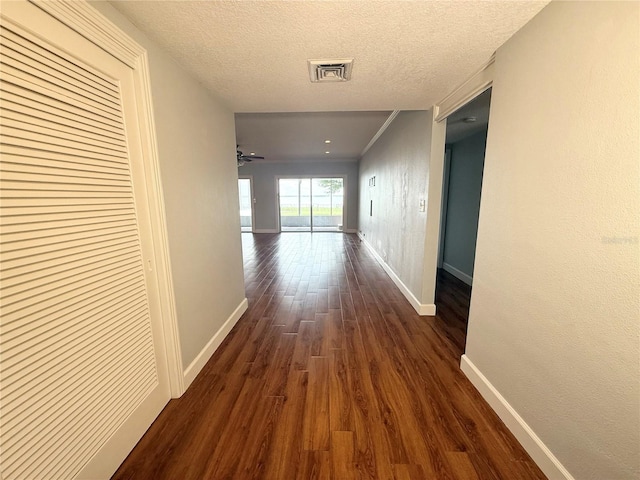 1328 Edgewater Beach Dr, Lakeland, FL 33805 - hall featuring baseboards, dark wood-style floors, and a textured ceiling