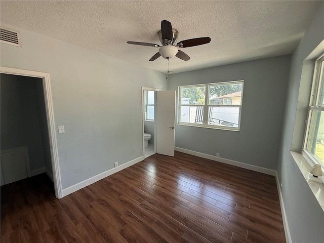 1328 Edgewater Beach Dr, Lakeland, FL 33805 - unfurnished room with a textured ceiling, dark wood finished floors, baseboards, and a ceiling fan