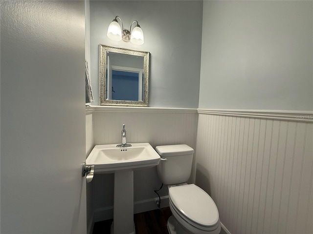 1328 Edgewater Beach Dr, Lakeland, FL 33805 - bathroom featuring a wainscoted wall and toilet