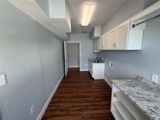 1328 Edgewater Beach Dr, Lakeland, FL 33805 - laundry area with cabinet space, a textured ceiling, baseboards, dark wood-style floors, and hookup for a washing machine