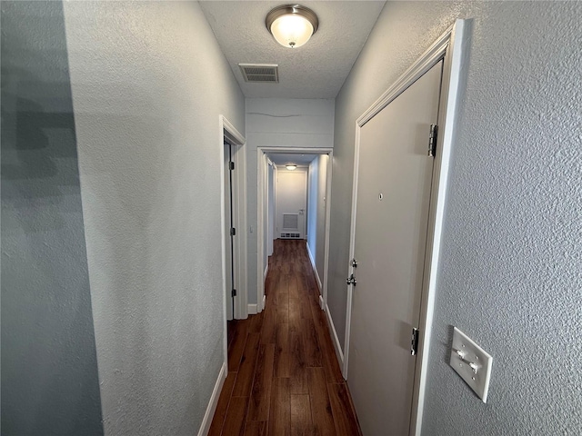 1328 Edgewater Beach Dr, Lakeland, FL 33805 - hall with wood finished floors, a textured ceiling, and a textured wall