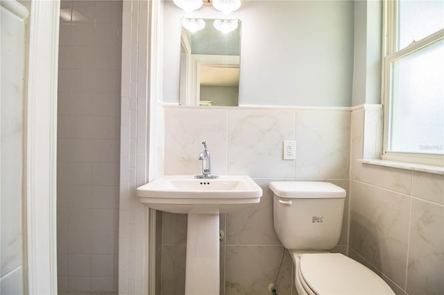 1328 Edgewater Beach Dr, Lakeland, FL 33805 - half bathroom with tile walls and healthy amount of natural light
