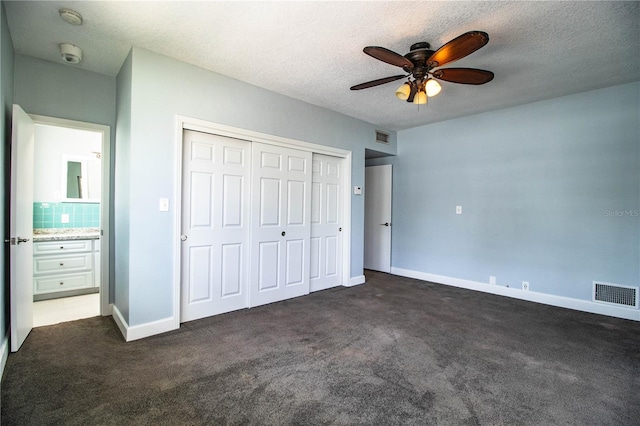1328 Edgewater Beach Dr, Lakeland, FL 33805 - unfurnished bedroom with dark carpet, a textured ceiling, a closet, and a ceiling fan