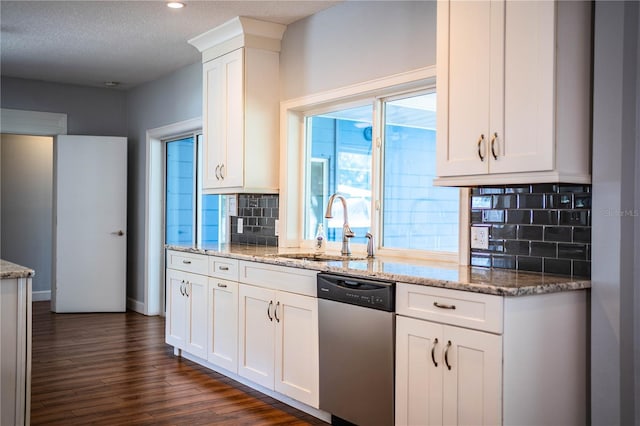 1328 Edgewater Beach Dr, Lakeland, FL 33805 - kitchen with dishwasher, decorative backsplash, white cabinetry, dark wood-style flooring, and light stone counters