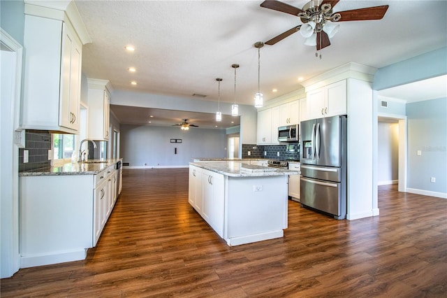 1328 Edgewater Beach Dr, Lakeland, FL 33805 - kitchen featuring stainless steel appliances, ceiling fan, a center island, recessed lighting, and decorative backsplash