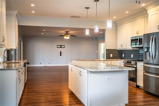 1328 Edgewater Beach Dr, Lakeland, FL 33805 - kitchen featuring stainless steel appliances, dark wood-style flooring, tasteful backsplash, a ceiling fan, and recessed lighting