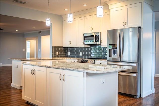 1328 Edgewater Beach Dr, Lakeland, FL 33805 - kitchen featuring stainless steel appliances, tasteful backsplash, dark wood finished floors, white cabinetry, and light stone counters