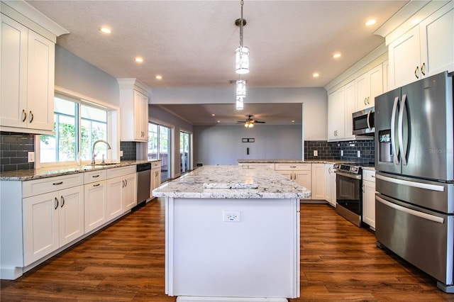 1328 Edgewater Beach Dr, Lakeland, FL 33805 - kitchen featuring stainless steel appliances, decorative backsplash, recessed lighting, and dark wood-style flooring