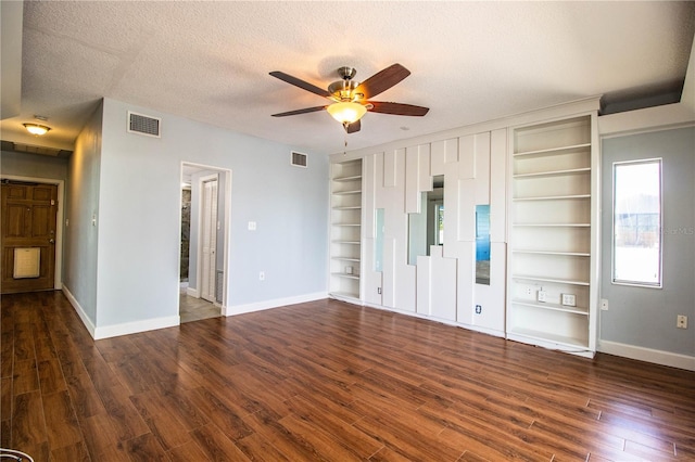 1328 Edgewater Beach Dr, Lakeland, FL 33805 - unfurnished living room with built in shelves, ceiling fan, wood finished floors, and a textured ceiling