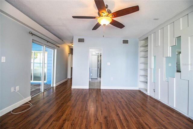1328 Edgewater Beach Dr, Lakeland, FL 33805 - unfurnished room with built in shelves, a ceiling fan, a textured ceiling, and wood finished floors