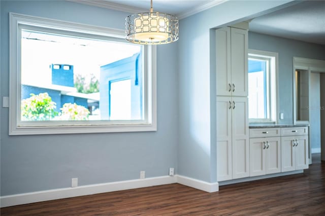 1328 Edgewater Beach Dr, Lakeland, FL 33805 - unfurnished dining area featuring dark wood finished floors and crown molding
