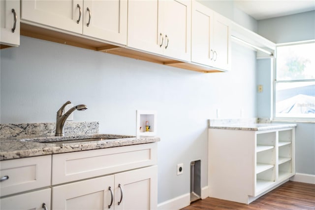 1328 Edgewater Beach Dr, Lakeland, FL 33805 - laundry area with electric dryer hookup, cabinet space, wood finished floors, and washer hookup