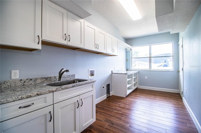 1328 Edgewater Beach Dr, Lakeland, FL 33805 - washroom featuring hookup for an electric dryer, hookup for a washing machine, dark wood-style floors, a textured ceiling, and cabinet space
