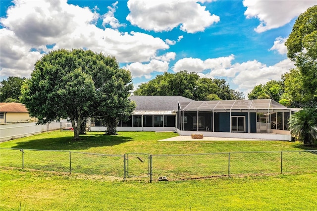 1328 Edgewater Beach Dr, Lakeland, FL 33805 - rear view of house with a gate, a fenced backyard, a lanai, and a sunroom