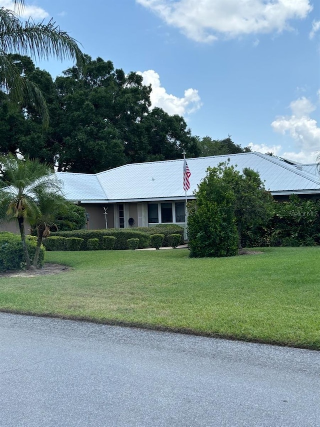 1110 Cypress Pt W, Winter Haven, FL 33884 - ranch-style house with metal roof and a front yard