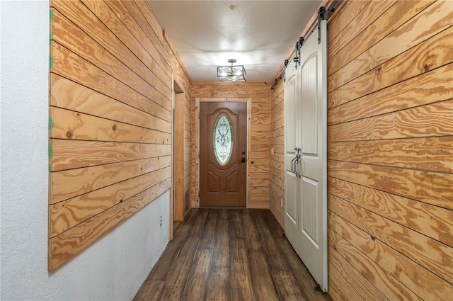 2219 New Jersey Rd, Lakeland, FL 33803 - doorway to outside with wood walls, dark wood-style floors, and a barn door