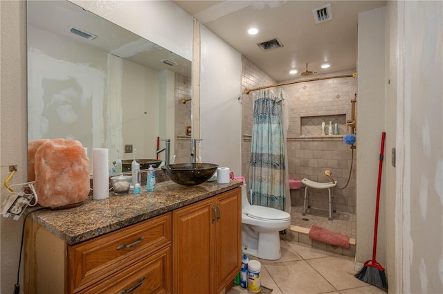 2219 New Jersey Rd, Lakeland, FL 33803 - bathroom with tile patterned floors, tiled shower, toilet, vanity, and recessed lighting