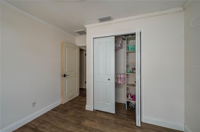 2219 New Jersey Rd, Lakeland, FL 33803 - unfurnished bedroom with ornamental molding, baseboards, wood finished floors, and a closet