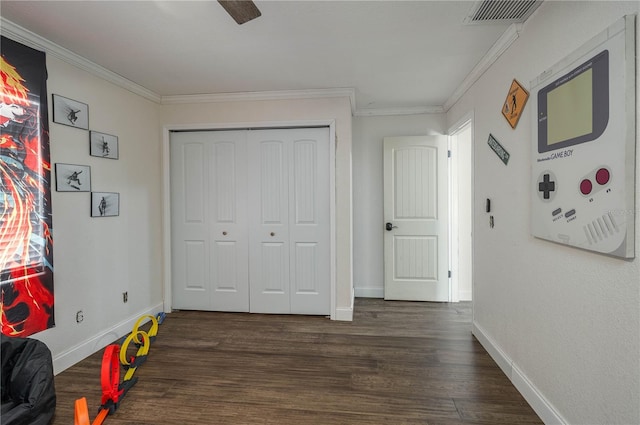 2219 New Jersey Rd, Lakeland, FL 33803 - bedroom with baseboards, ornamental molding, dark wood finished floors, a closet, and a ceiling fan