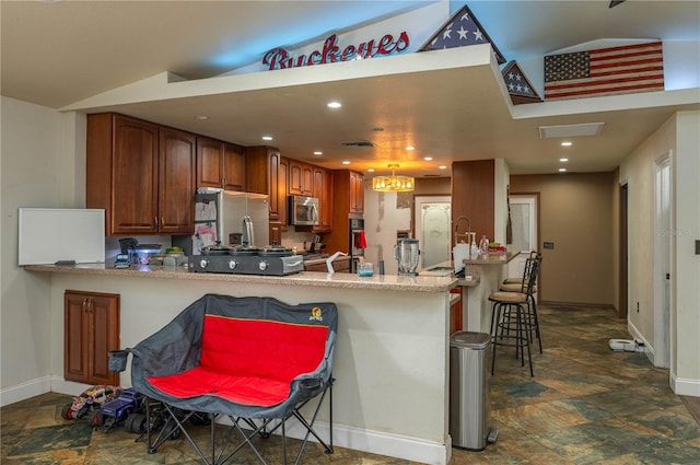 2219 New Jersey Rd, Lakeland, FL 33803 - kitchen featuring stainless steel appliances, a peninsula, stone finish floors, baseboards, and recessed lighting