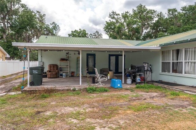 2219 New Jersey Rd, Lakeland, FL 33803 - rear view of property with a patio area, fence, stucco siding, and metal roof