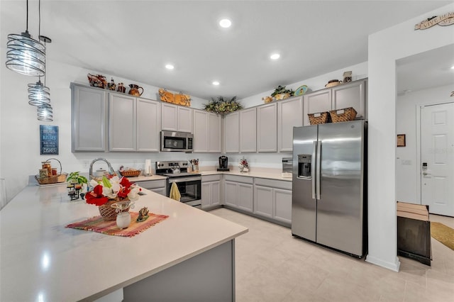 280 Pershing St, Bartow, FL 33830 - kitchen featuring appliances with stainless steel finishes, gray cabinetry, light countertops, recessed lighting, and hanging light fixtures