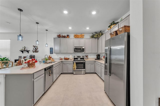 280 Pershing St, Bartow, FL 33830 - kitchen with appliances with stainless steel finishes, gray cabinetry, a sink, a peninsula, and recessed lighting
