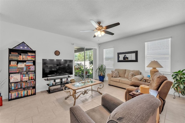 280 Pershing St, Bartow, FL 33830 - living area featuring a ceiling fan, a textured ceiling, tile patterned flooring, and baseboards