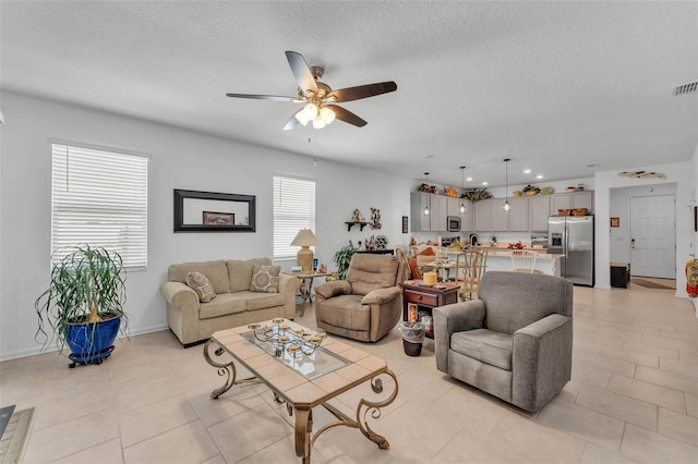 280 Pershing St, Bartow, FL 33830 - living room with a ceiling fan, a textured ceiling, light tile patterned floors, and baseboards